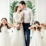 children covered their eyes while kissing at a wedding